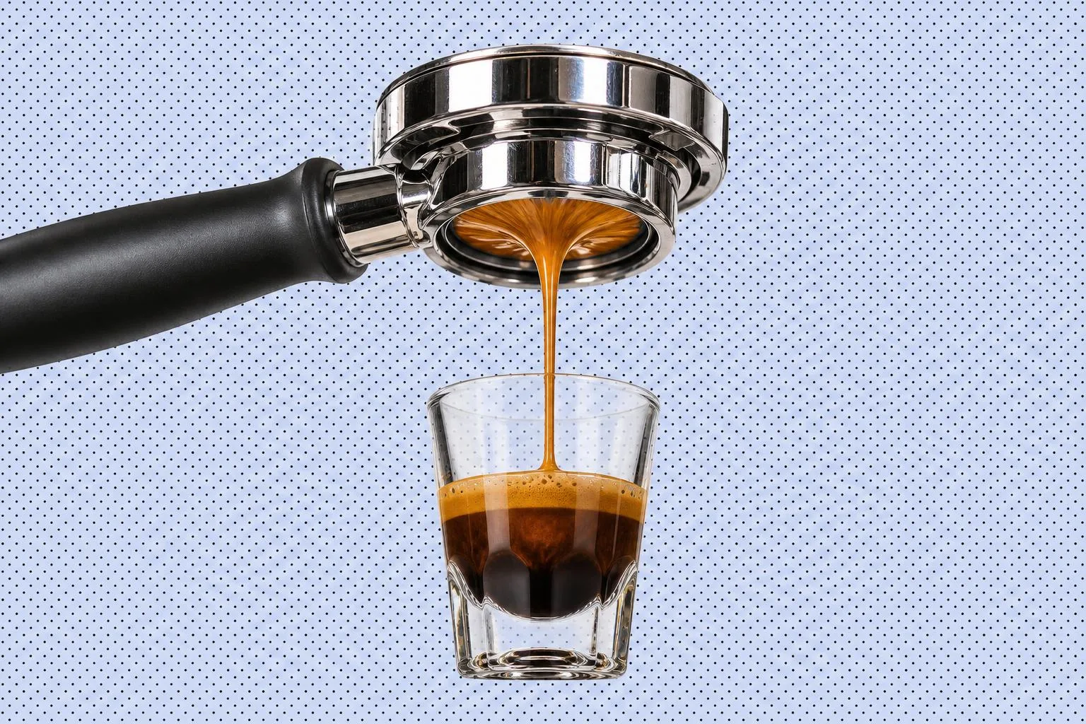 A bottomless espresso portafilter pulling a glossy shot into a small glass, set against a stylised patterned field